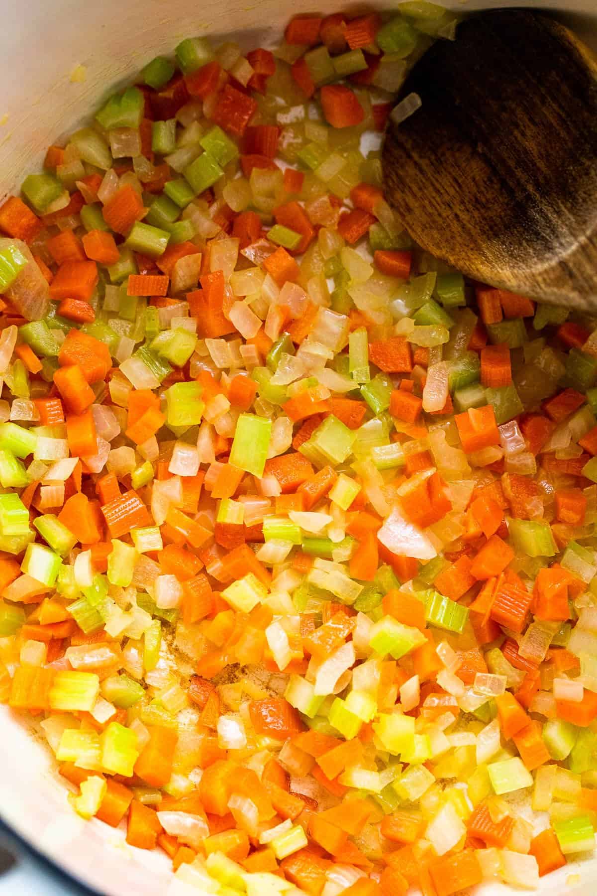 frying carrots and celery in a dutch oven