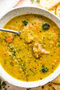 split pea soup served in a bowl with a spoon inside