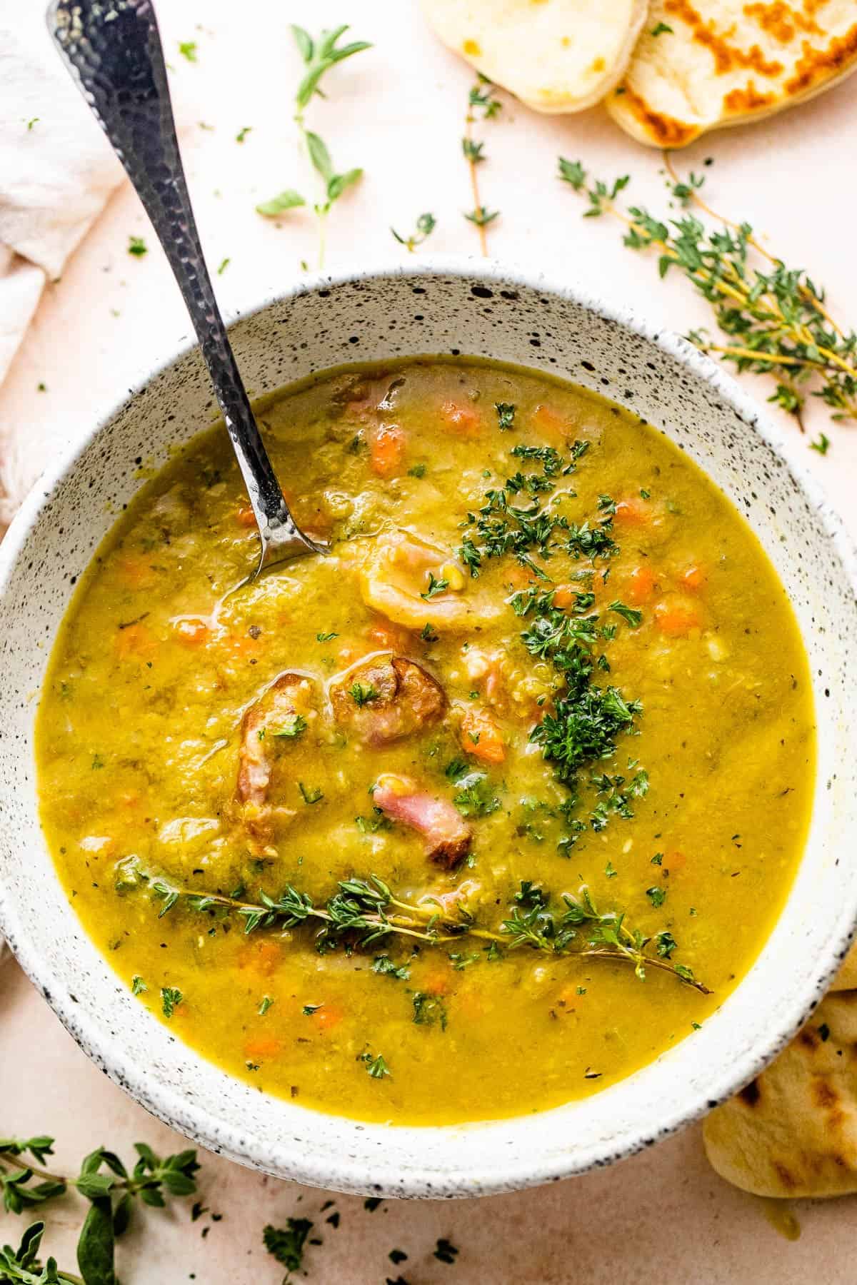 overhead shot of split pea soup served in a bowl with a spoon inside