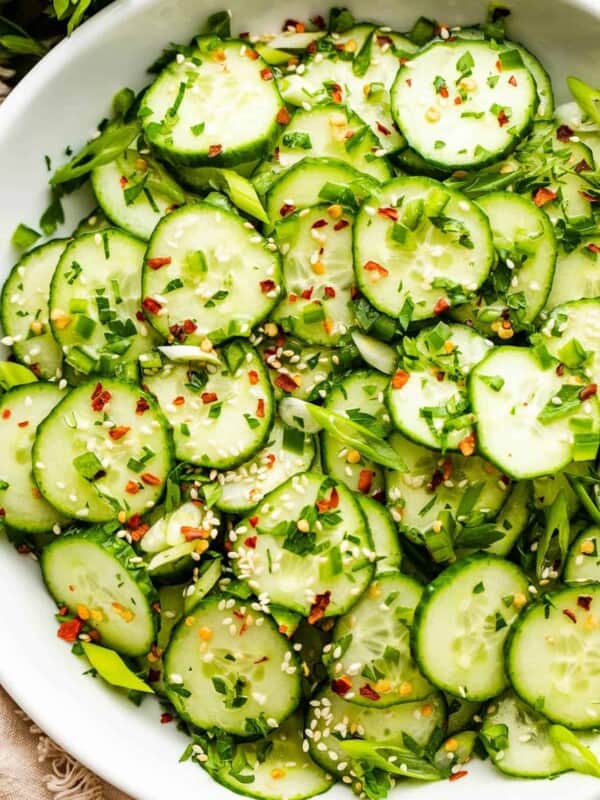 sesame cucumber salad served in a white salad bowl