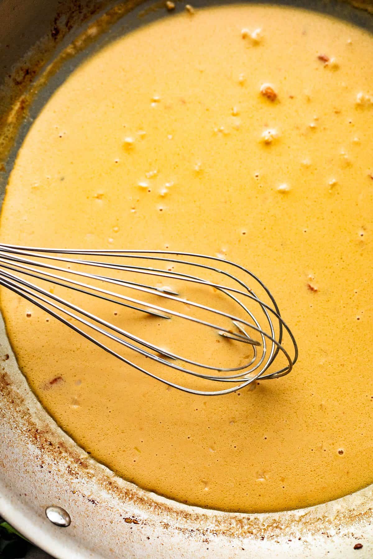 cooking and whisking lemon butter sauce