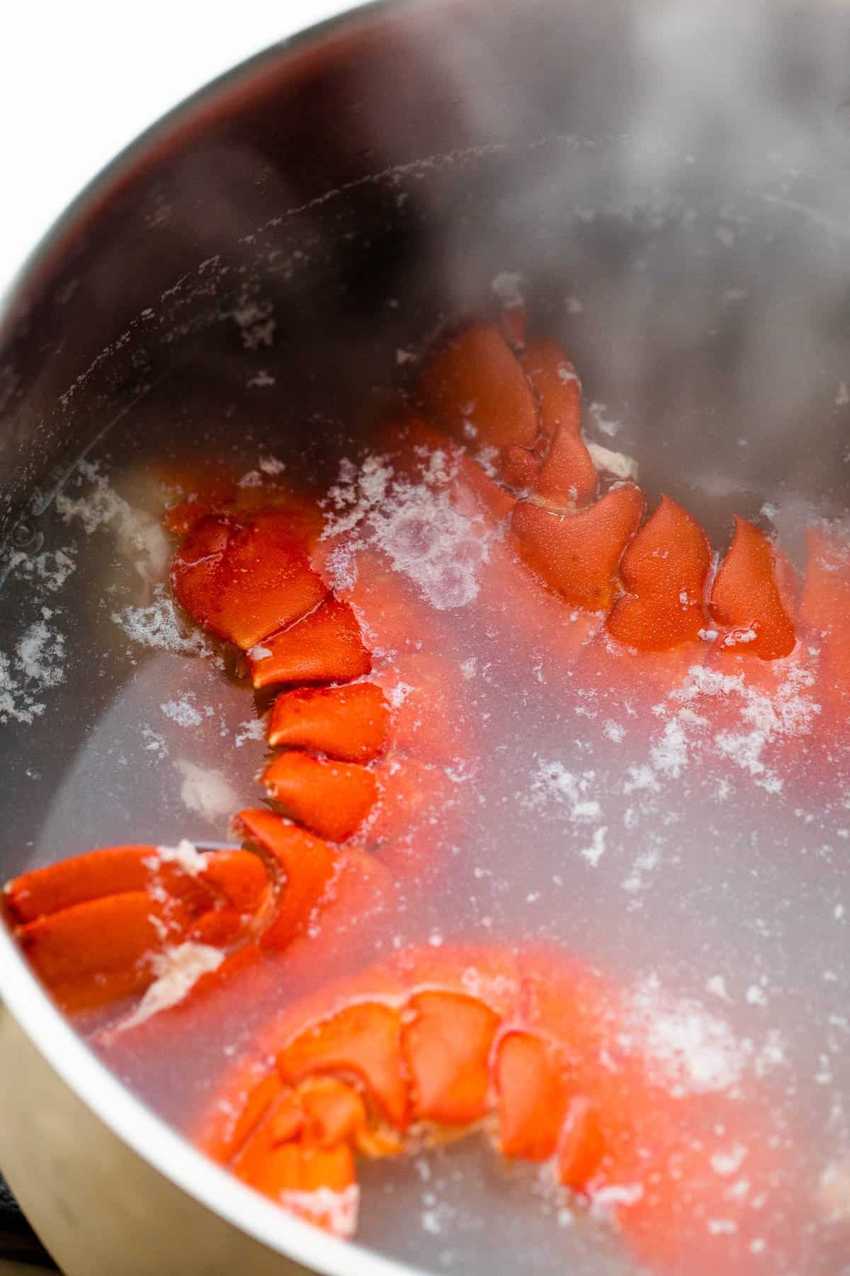boiling lobster tails in a pot
