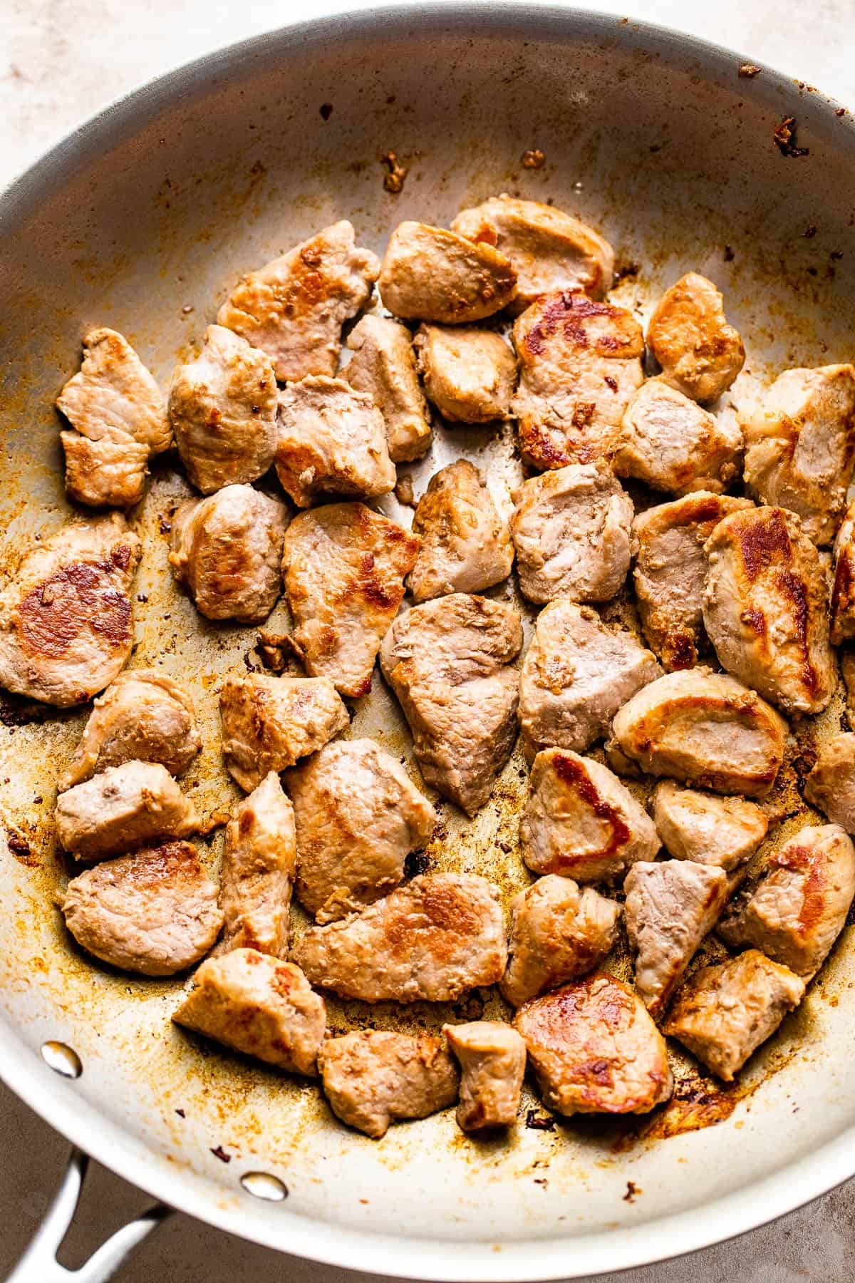 This homemade Pork Chop Suey recipe is a quick and easy Chinese-American stir-fry that features tender bites of pork, veggies, and a delicious sauce! cooking cut up pork tenderloin in a skillet