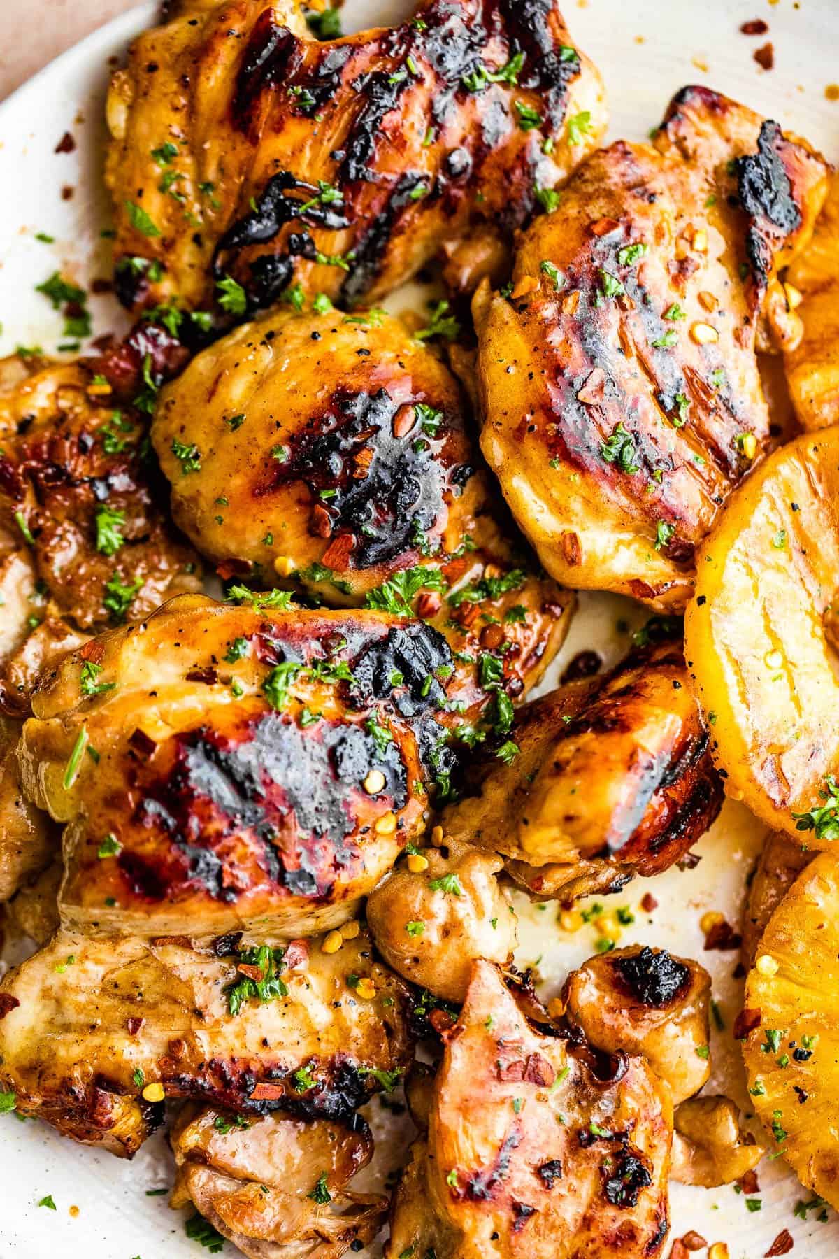 up close shot of grilled chicken thighs served on a plate