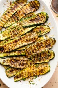 grilled zucchini slices served on an oval serving plate