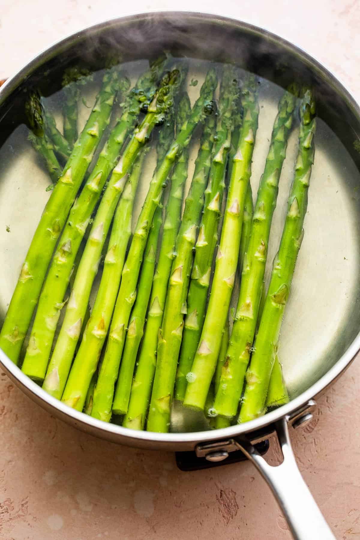 boiling asparagus in a stainless steel pan