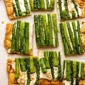 cheesy asparagus puff pastry tart cut up into nine pieces