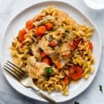 Chicken Paprikash on a Plate Over Pasta with a Gold Fork