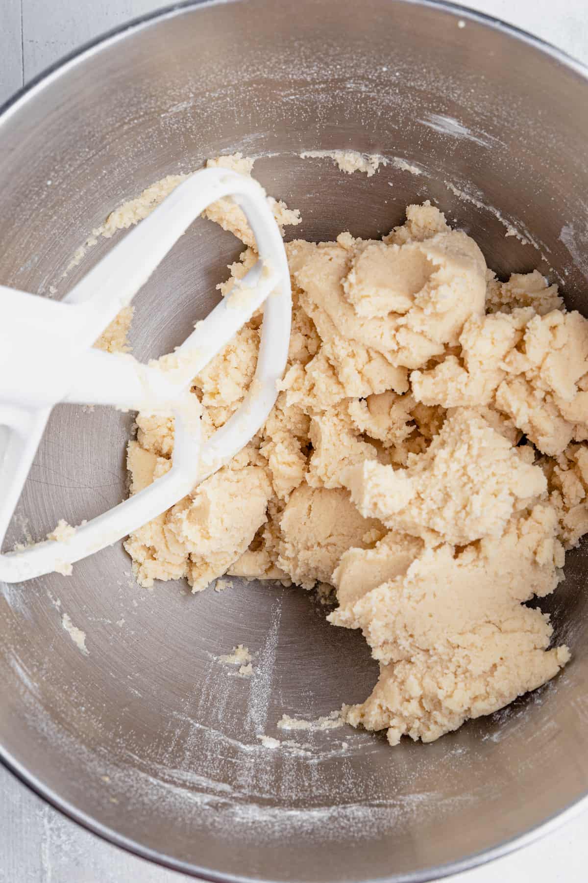Sugar Cookie Dough Inside of a Metal Mixing Bowl on a Countertop