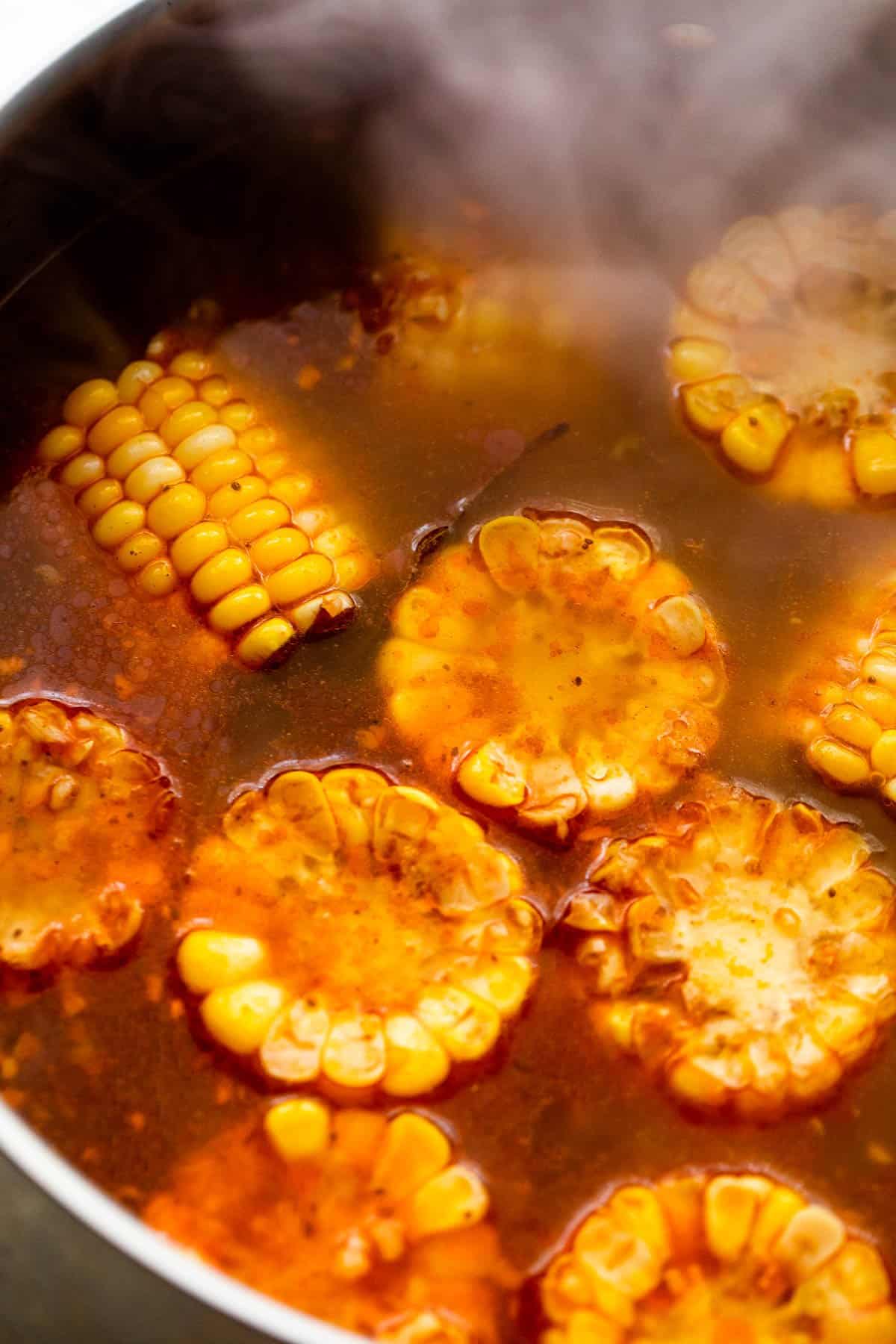 Boiling corn on the cob in a stockpot.