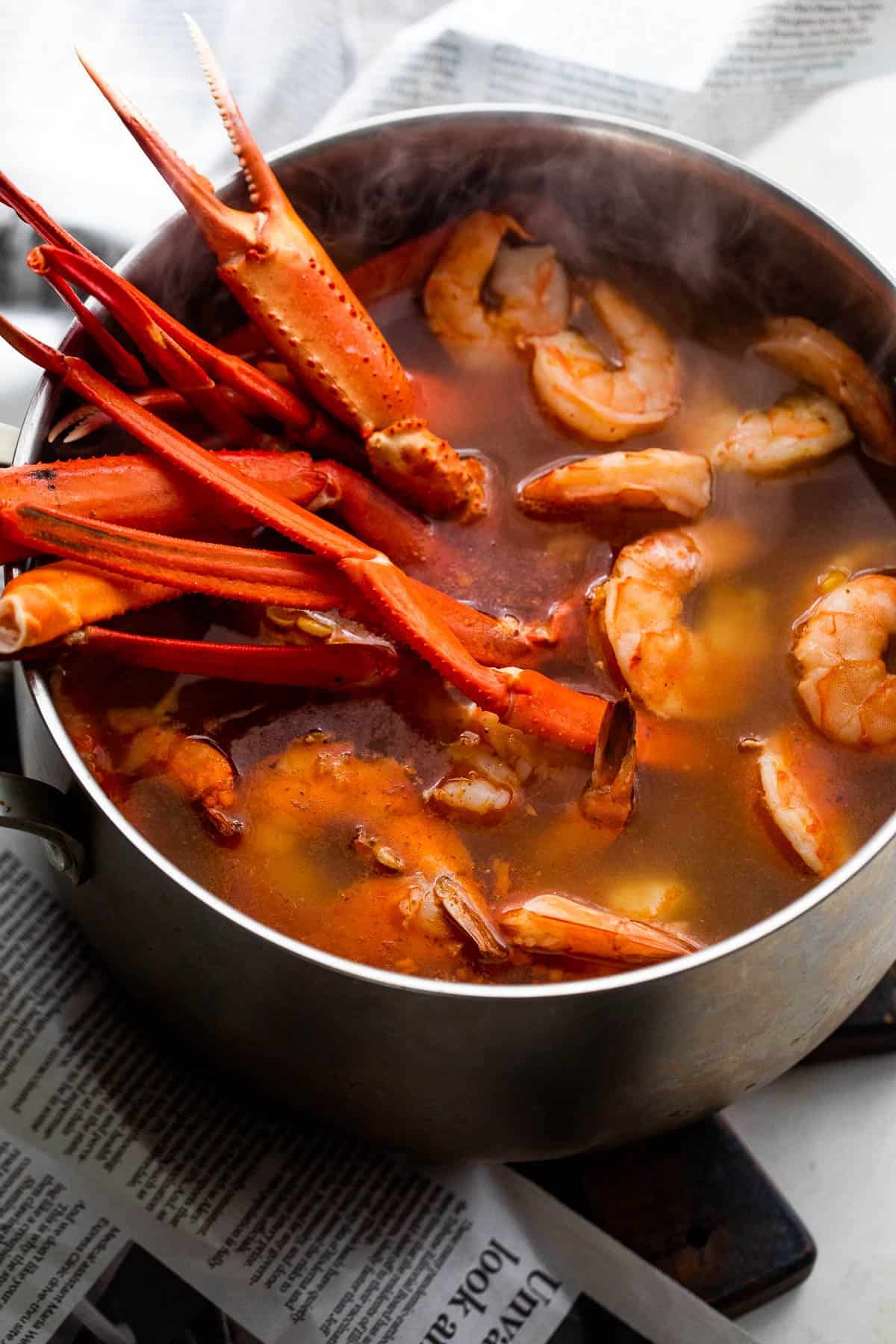 boiling crab legs and shrimp in a stockpot