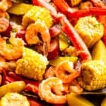 shot of seafood boil with crab legs, shrimp, corn, potatoes, and sausages