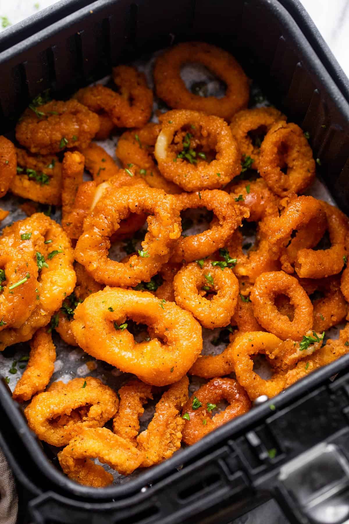 fried calamari in black air fryer basket