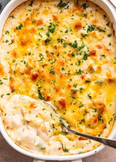 overhead shot of a cooked cheesy chicken zucchini casserole in a baking dish