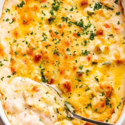 overhead shot of a cooked cheesy chicken zucchini casserole in a baking dish
