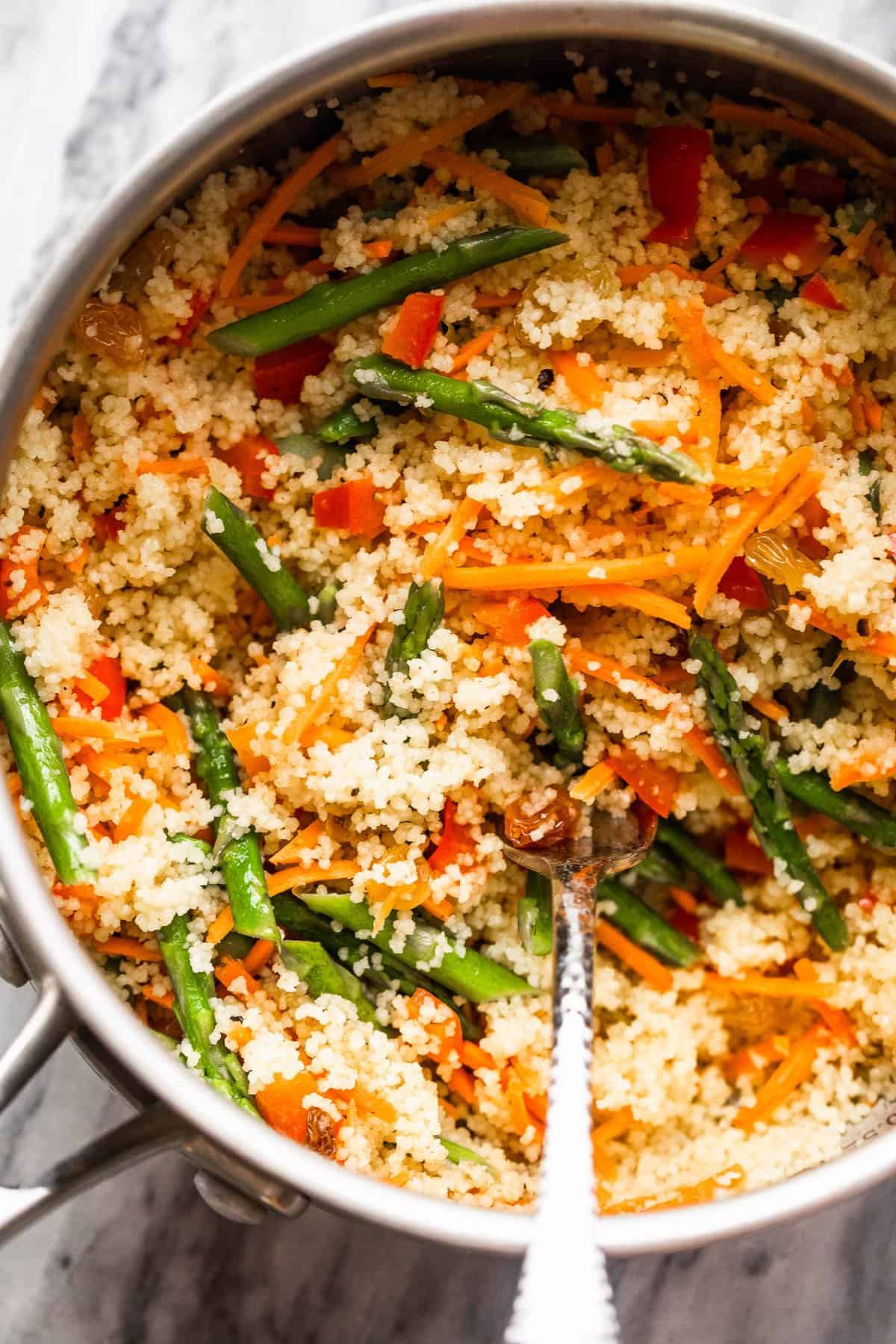 saucepan with boiled couscous with vegetables.