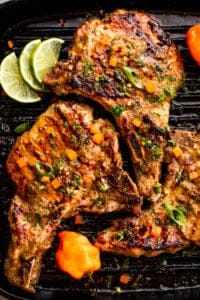 overhead shot of three jerk sauce grilled pork chops