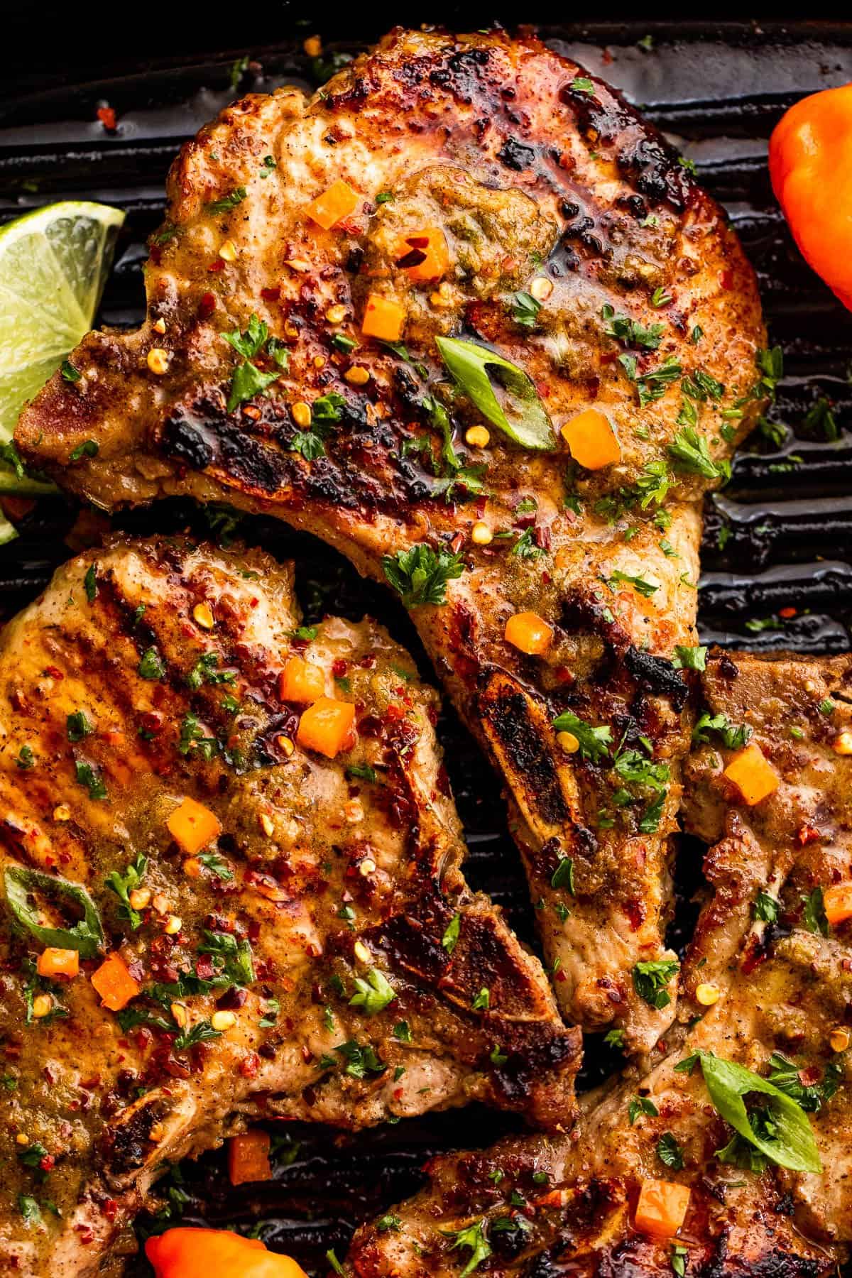 overhead shot of three jerk sauce grilled pork chops