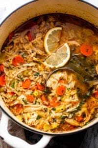 overhead shot of chicken orzo soup in a dutch oven