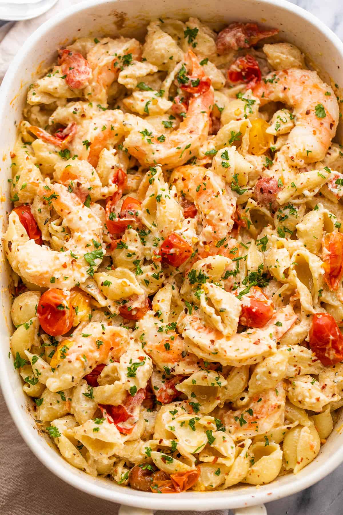 overhead shot of Baked Cream Cheese Pasta with Shrimp in a white baking dish.