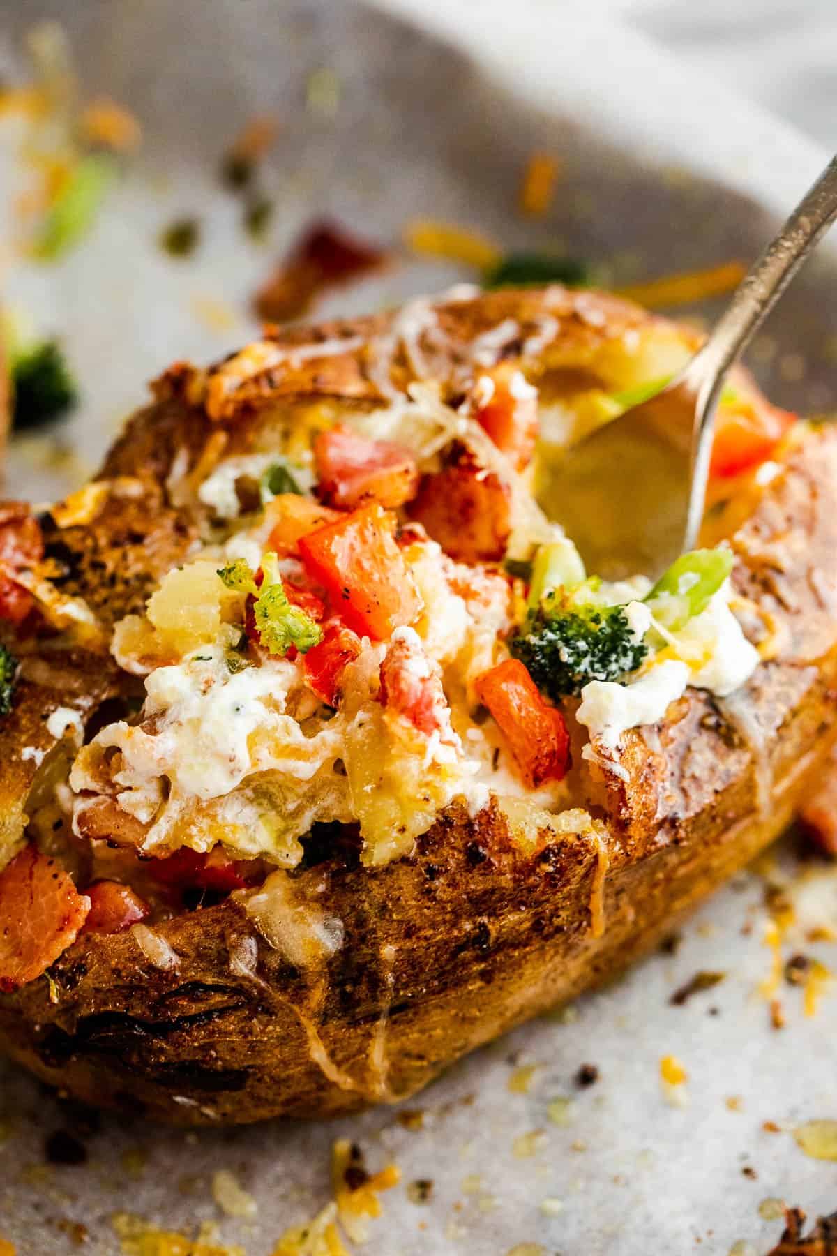 baked potato loaded with bacon, broccoli, and cheese.