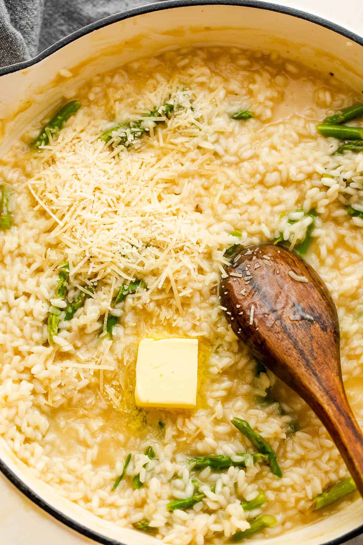 Adding butter and asparagus tips to risotto.