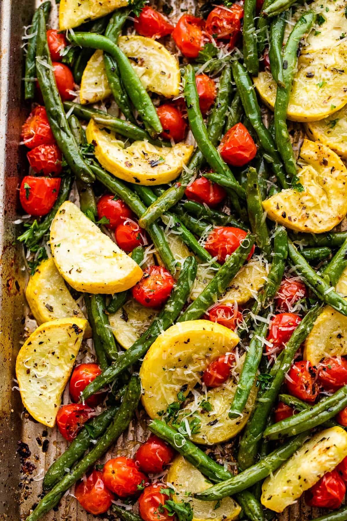 roasted cherry tomatoes, green beans, and yellow squash, and topped with shredded parmesan cheese