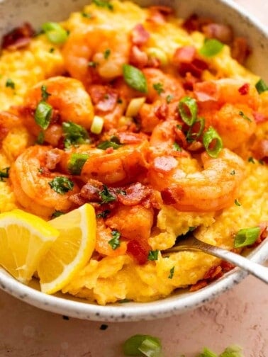 side view of a bowl with slow cooker grits topped with shrimp, bacon, and green onions