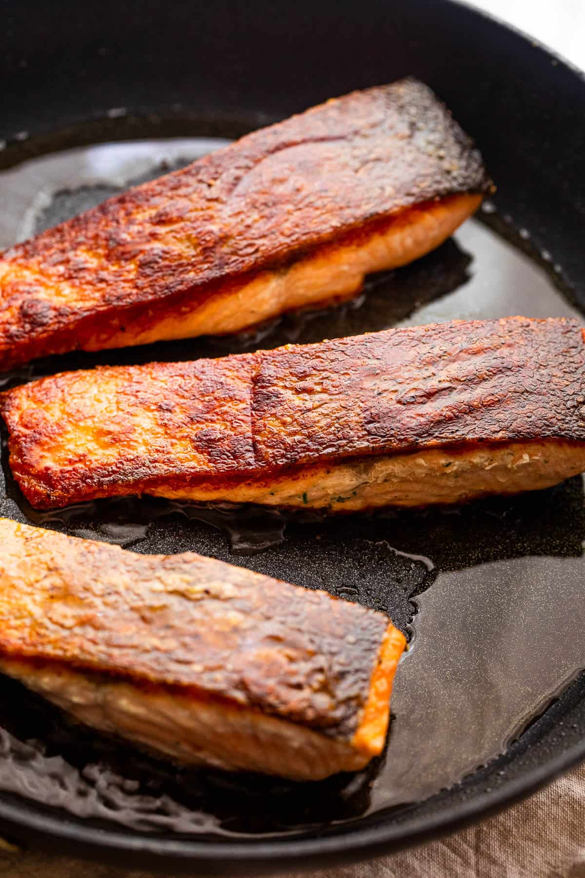 Pan frying salmon fillets.