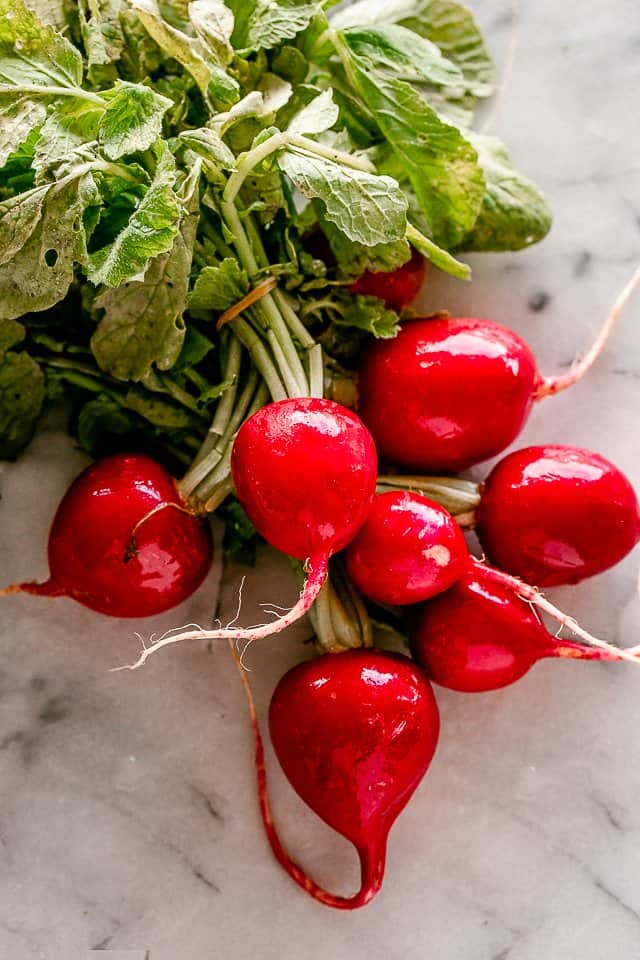 raw radishes on a vine