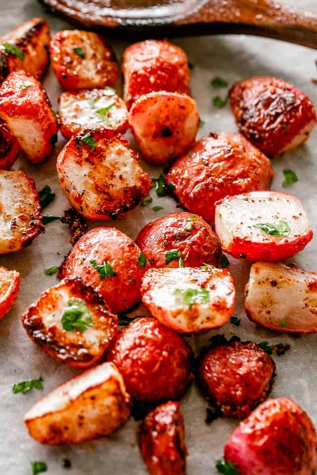 roasted radishes on a baking sheet covered with parchment paper