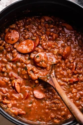 overhead shot of a pot with baked beans and sausage.