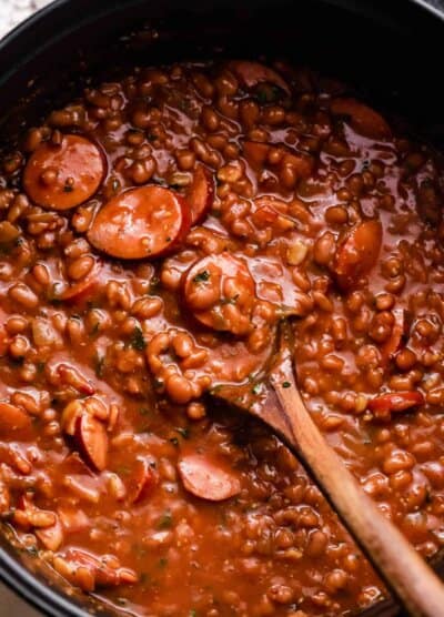 overhead shot of a pot with baked beans and sausage.