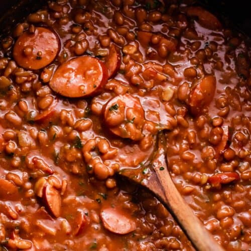 overhead shot of a pot with baked beans and sausage.