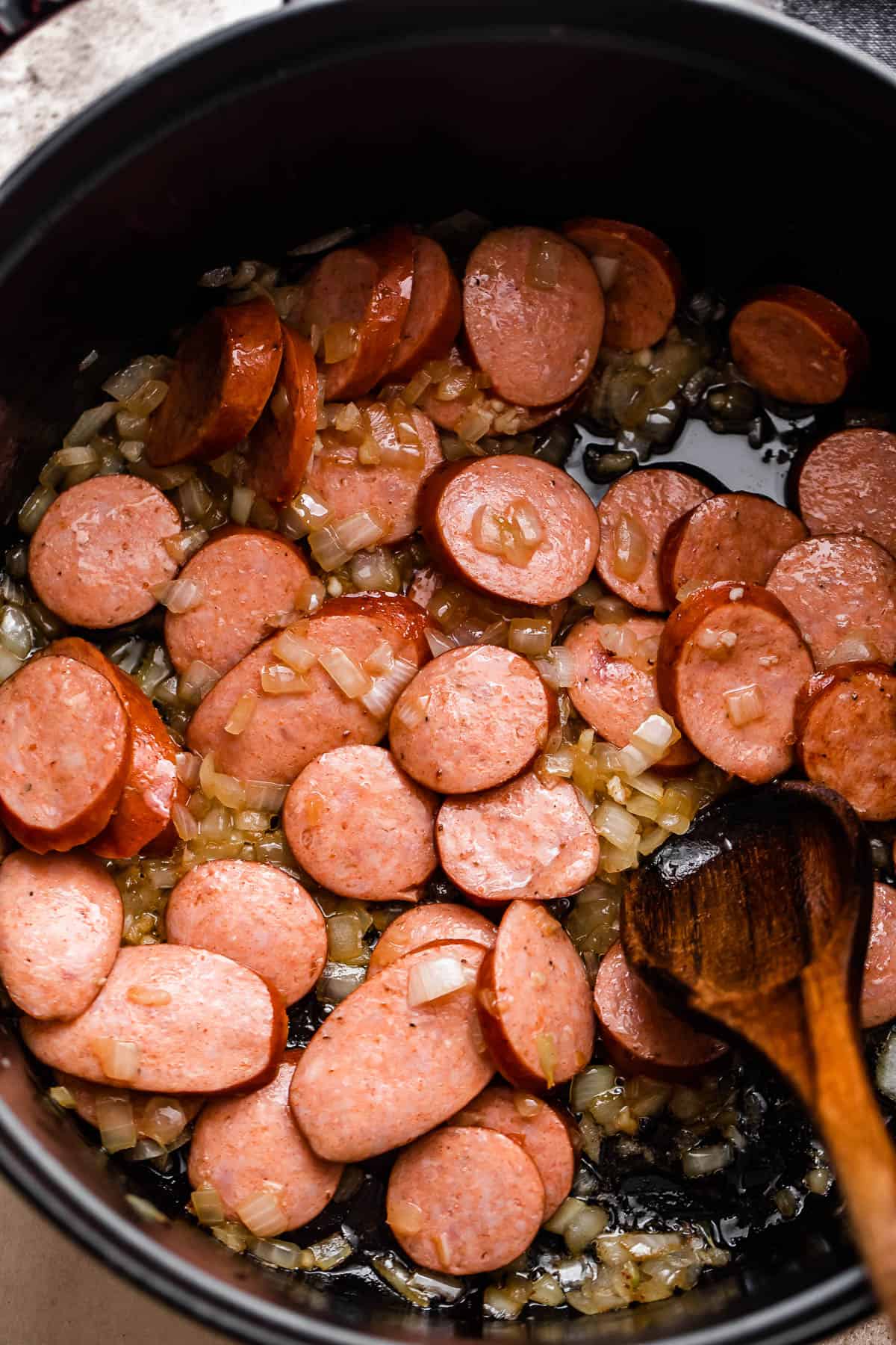 browning smoked sausage slices in a dutch oven.