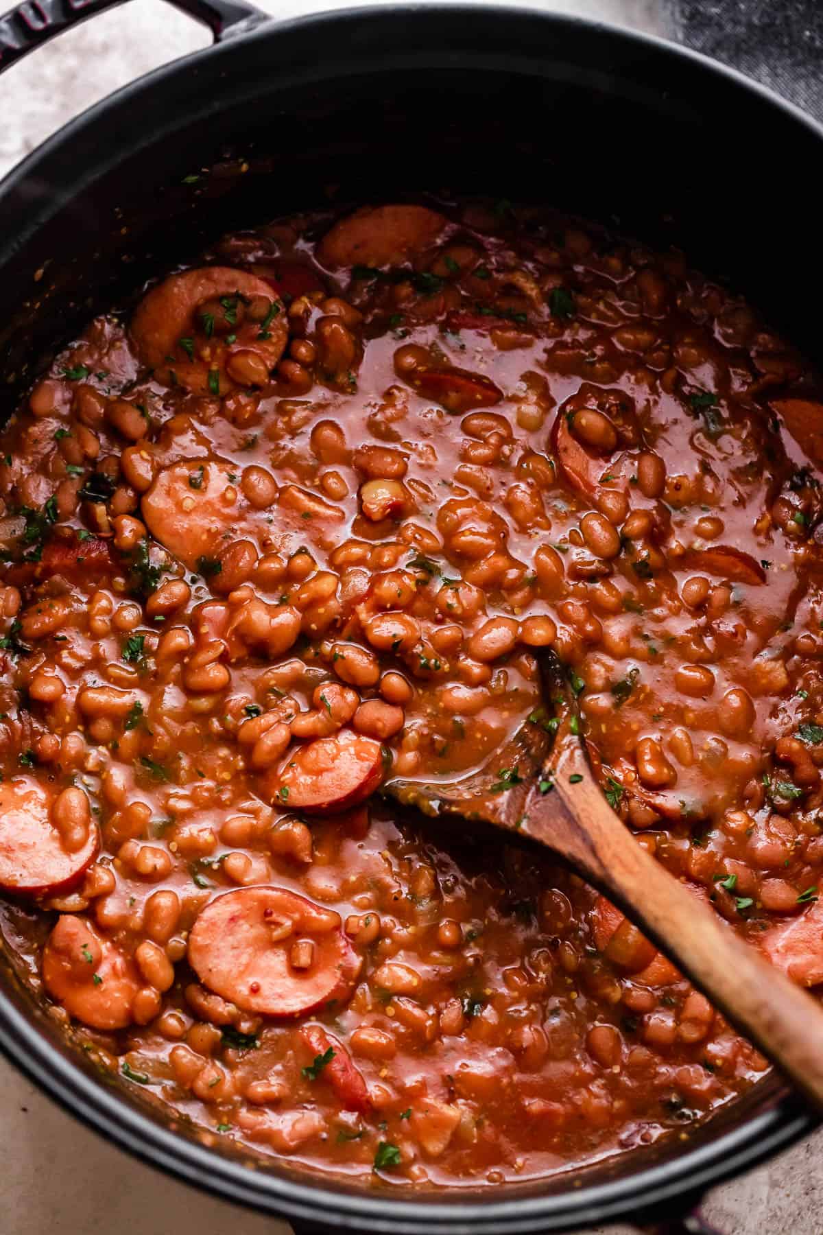 overhead shot of a pot with baked beans and sausage.