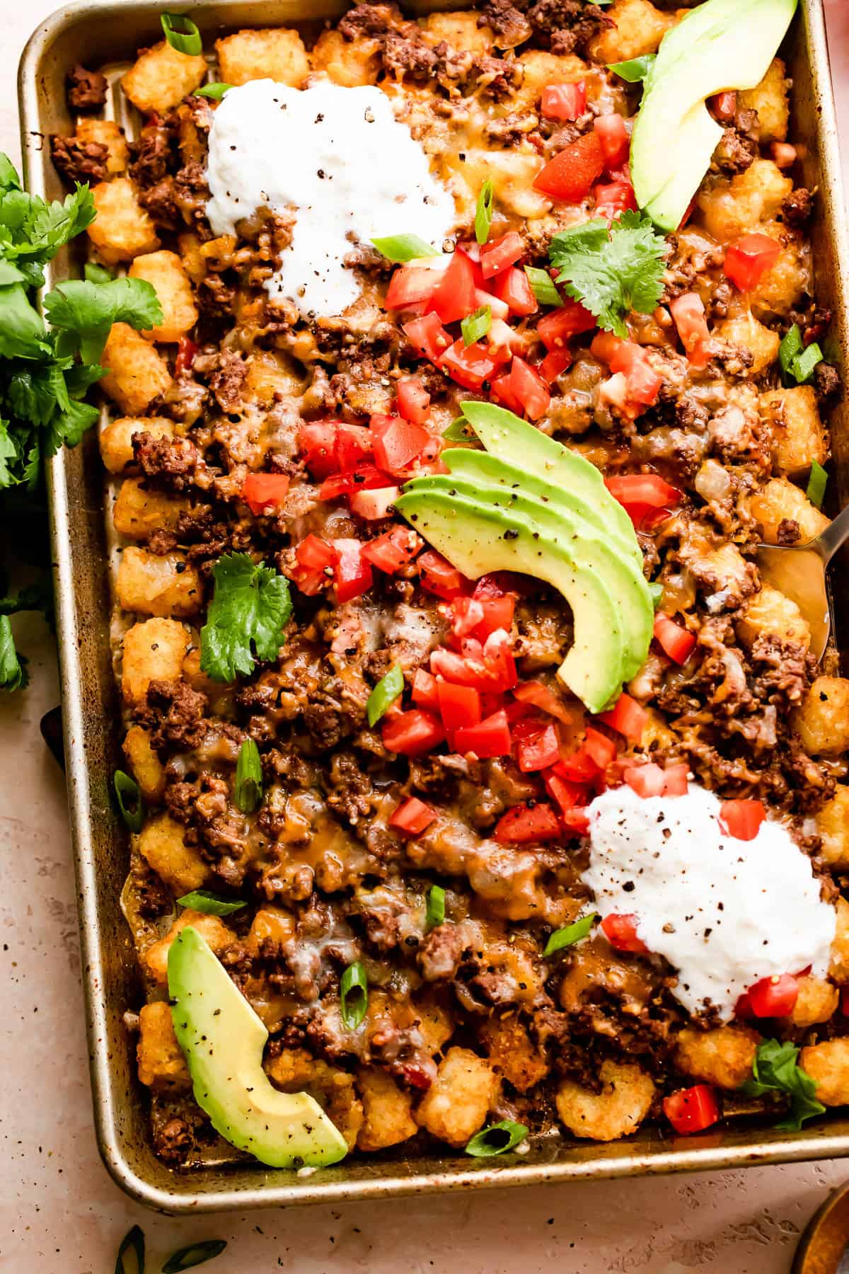 overhead shot of beef topped totchos on a Sheet Pan