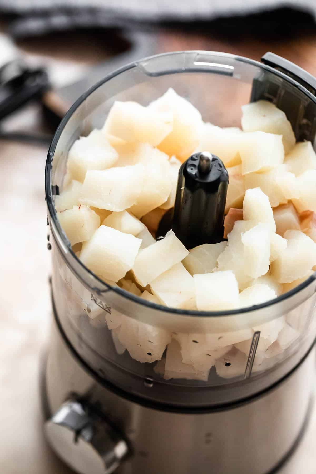 white fish chunks set in a food processor.