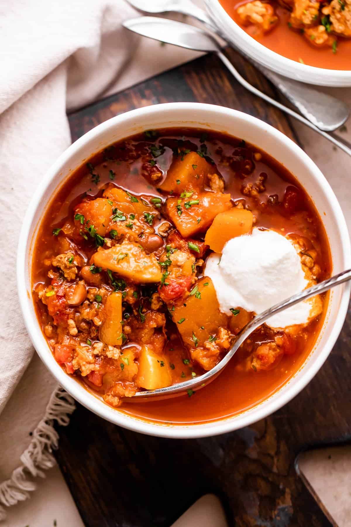 Weekly Menu Plan overhead shot of turkey chili in a white soup bowl.