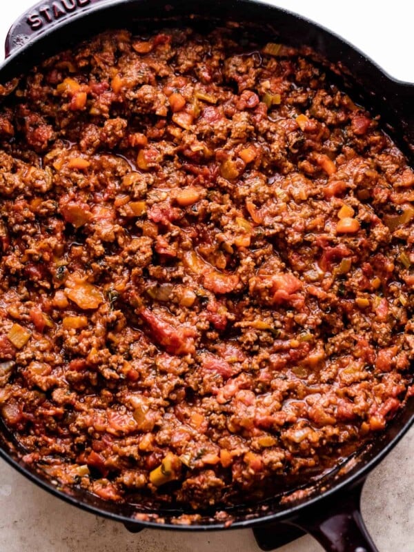 cooking Homemade Bolognese Sauce in a dark cast iron skillet