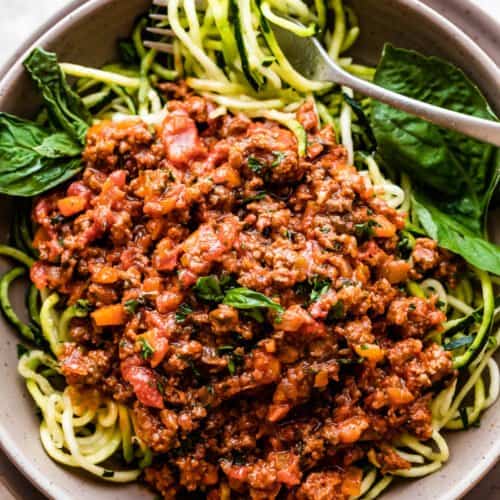 overhead shot of a bowl filled with zoodles and topped with Homemade Bolognese Sauce