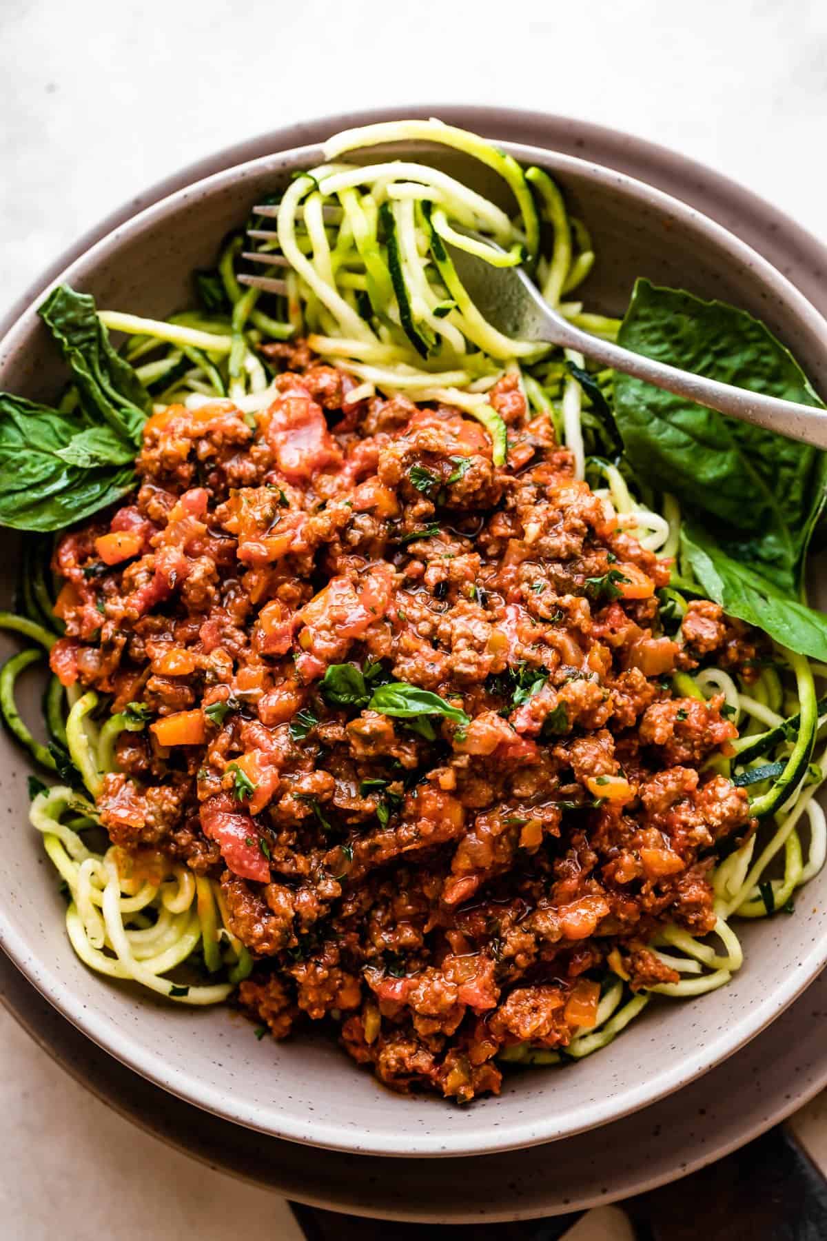 overhead shot of a bowl filled with zoodles and topped with Homemade Bolognese Sauce