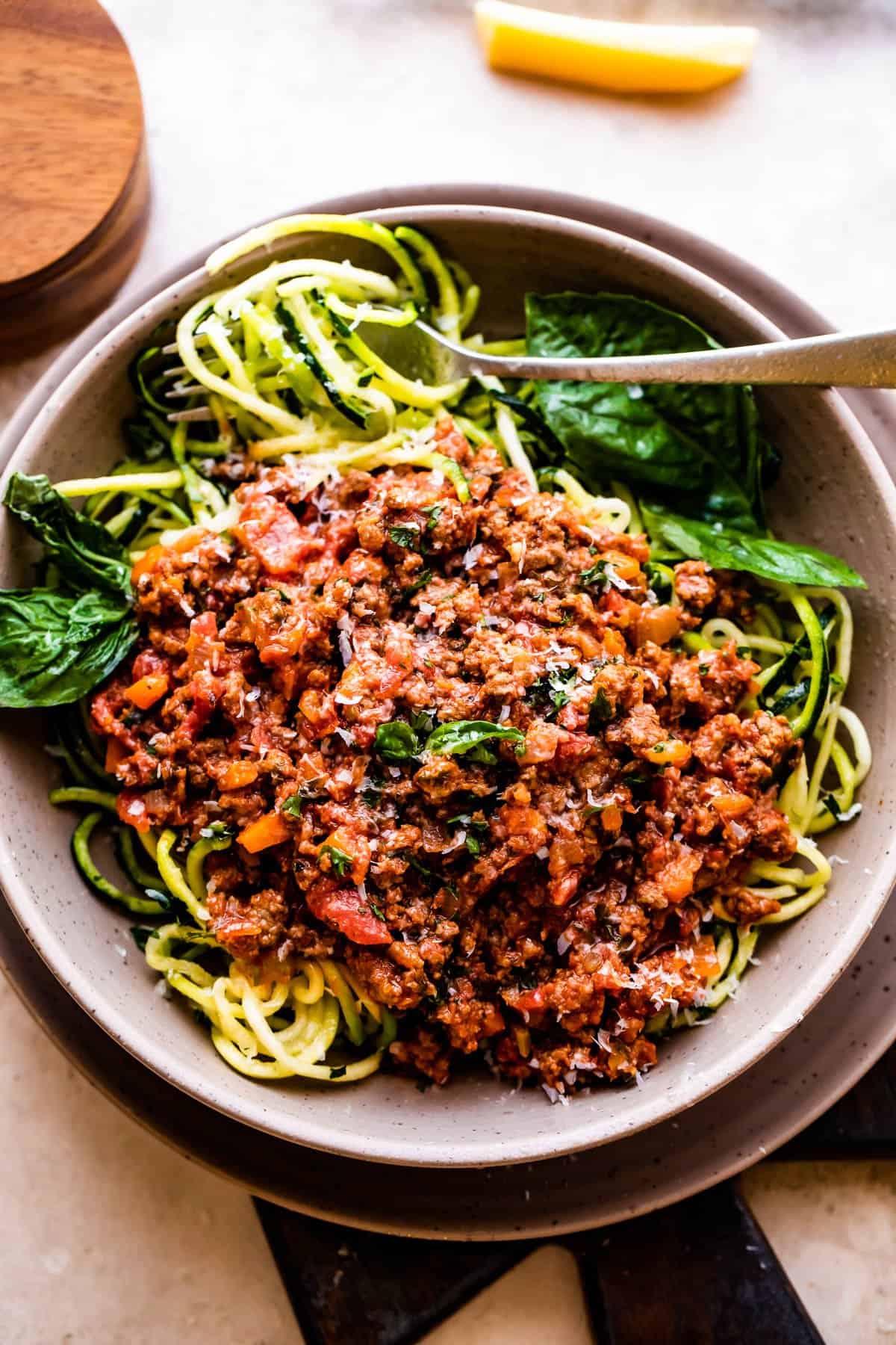 overhead shot of a bowl filled with zoodles and topped with Homemade Bolognese Sauce