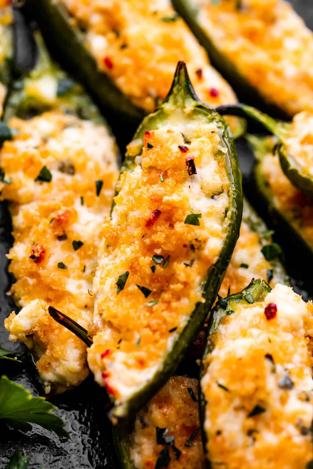 up close photo of jalapeno poppers arranged on a plate.