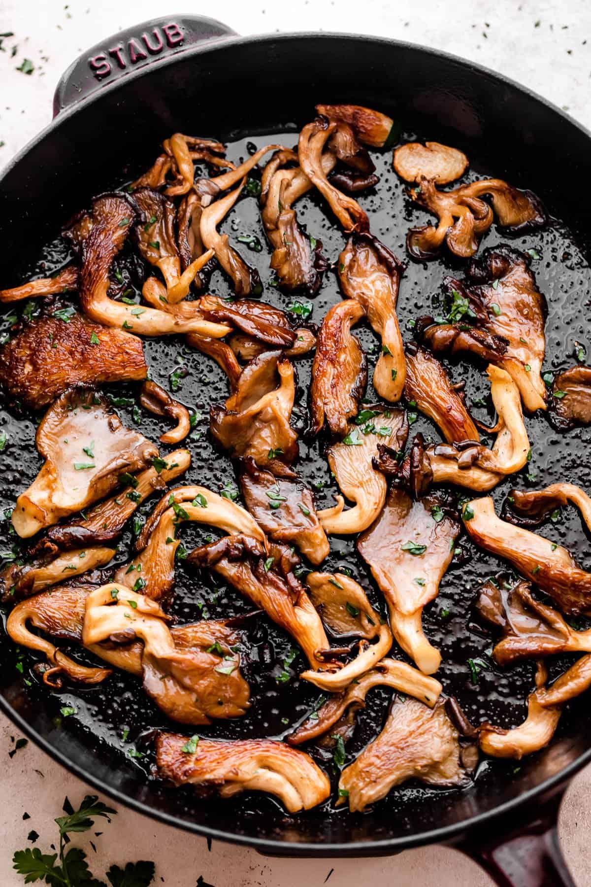 cooking oyster mushrooms in a heavy skillet