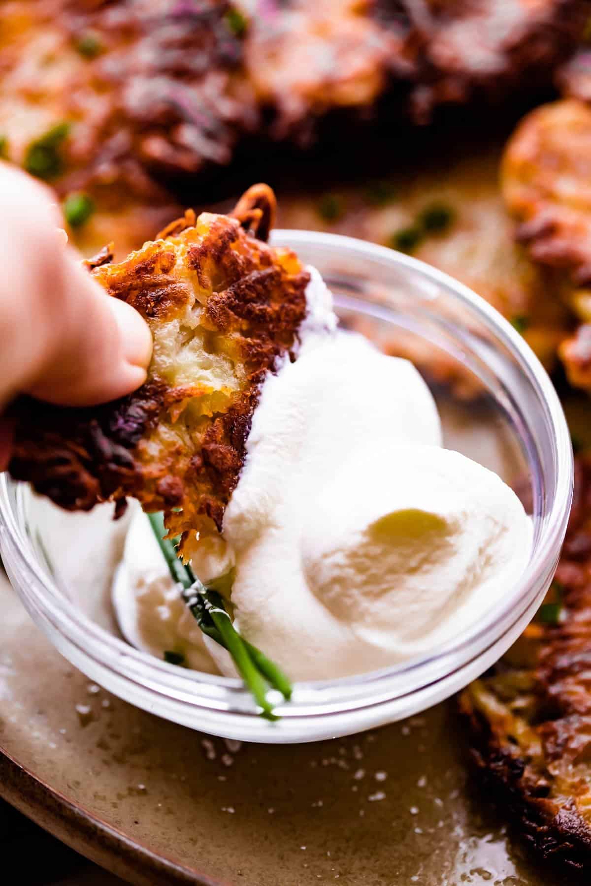 dipping a latke in sour cream.