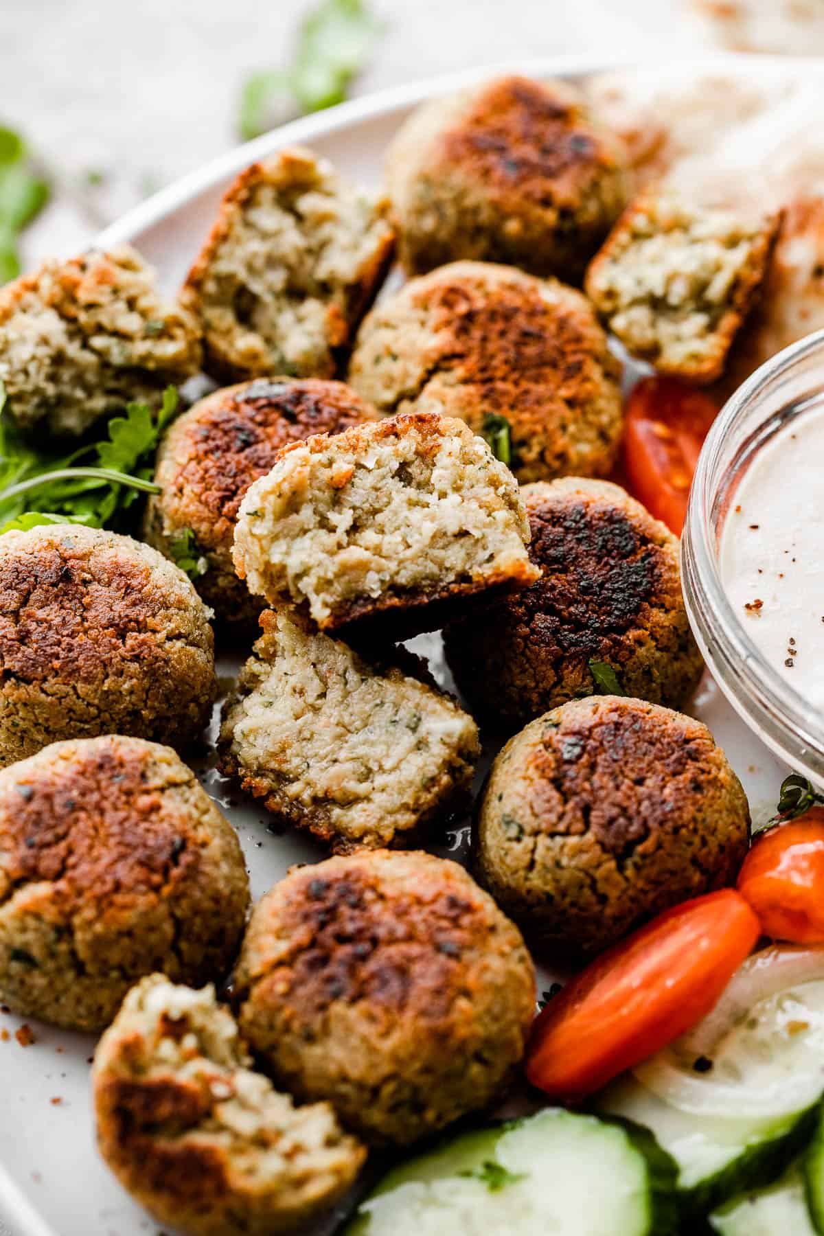 side shot of falafel arranged on a plate.