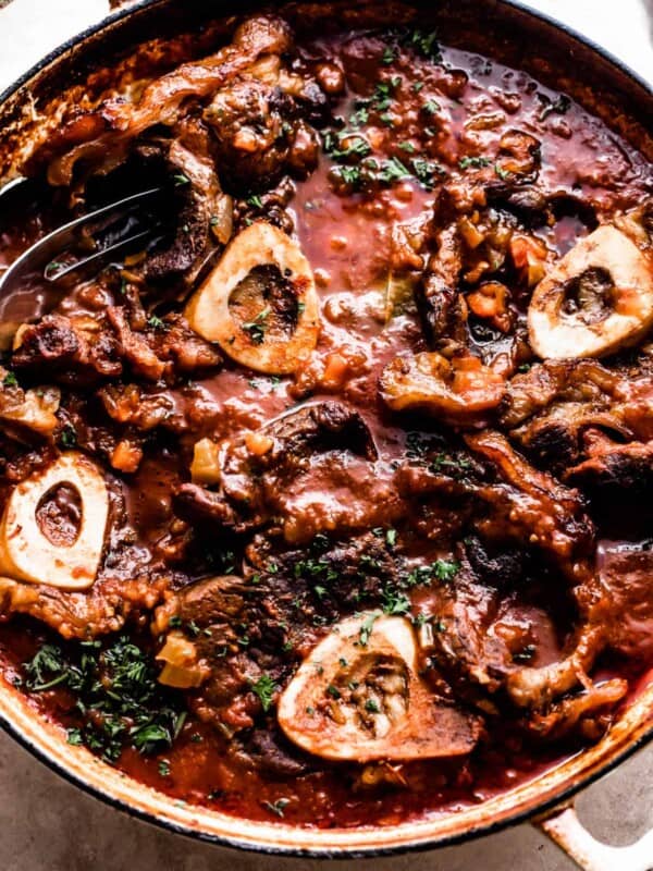 Four bone in beef shanks cooked in a braiser with tomato sauce.