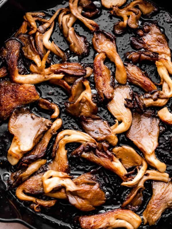 up close photo of cooking oyster mushrooms in a heavy skillet