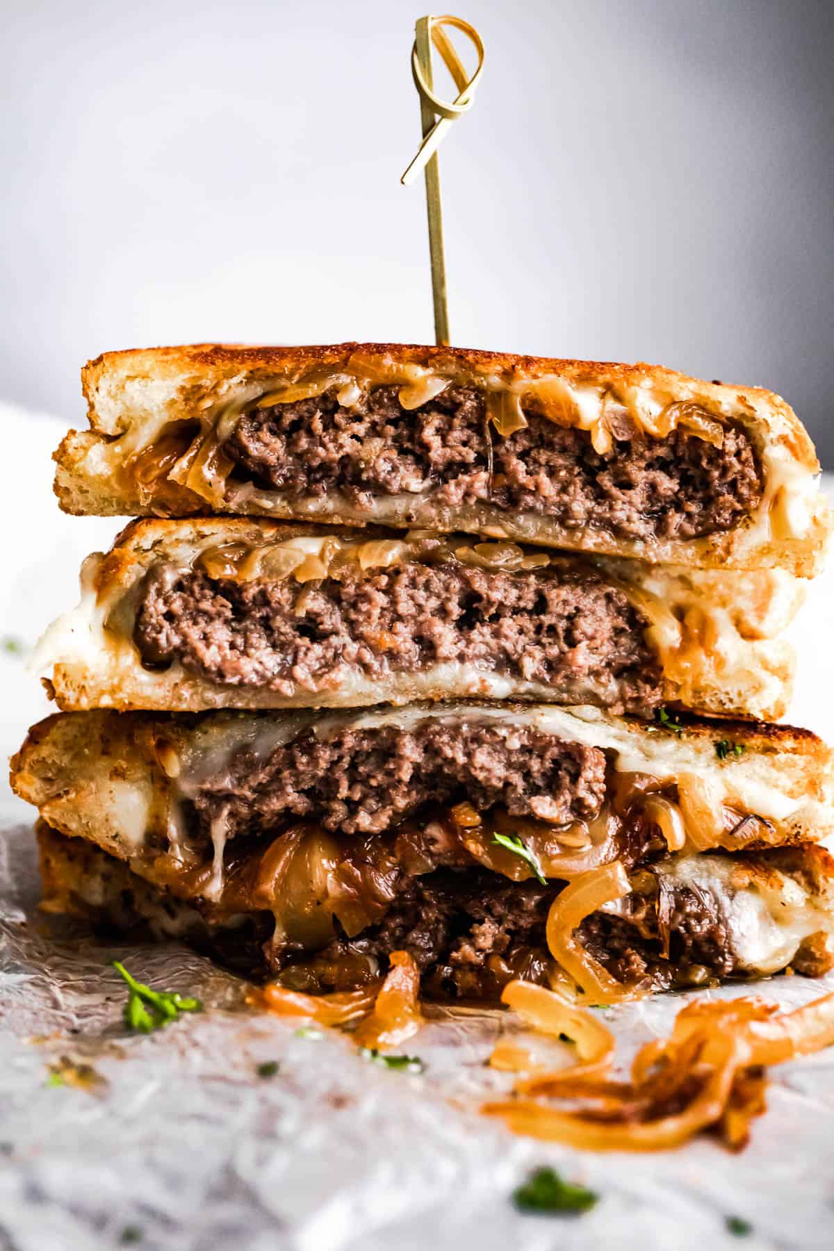 four stacked patty melt sandwiches.